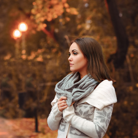 Young woman portrait autumn evening park.の写真素材