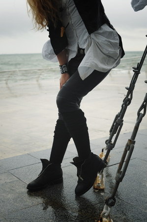 Female fashion legs dressed in leather pants, winter outdoor