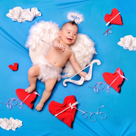 Baby cupid with angel wings, bow and arrows, textile decorationの写真素材