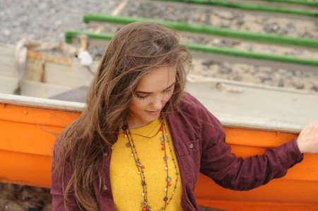 Autumn casual outfit woman portrait, dressed in yellow sweater and necklaceの写真素材