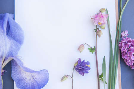 Spring background mockup with empty white space drawing notebook with violet and pink flowers