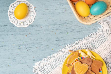 White empty list Easter background with colored eggs and holiday homemade cookiesの写真素材