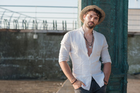 Young man portrait outdoor near the sea in big cityの写真素材