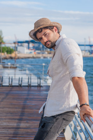 Young handsome man portrait outdoor near the sea in big cityの写真素材