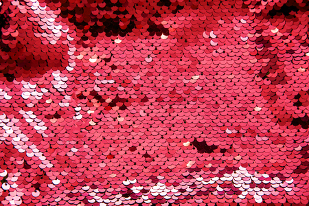 Bright pink glance background made of two-sided sequins. Holiday concept.の写真素材