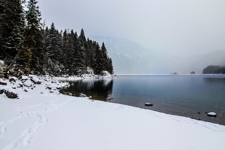 Snowfall over the lake, Beautiful winter landscapeの写真素材