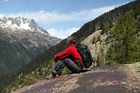 Tourist hiker enjoying view of mountains in French Alpsの写真素材