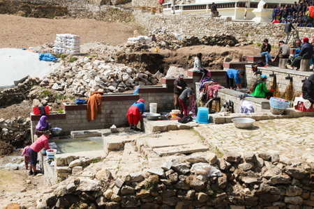 NEPAL, NAMCHE BAZAAR-APRIL, 24. Group of Nepalese women washing clothes in riverのeditorial素材