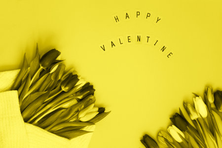 Bouquet of tulips on yellow background. Greeting for Valentine Dayの写真素材