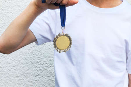 Gold medal in the boy handの写真素材