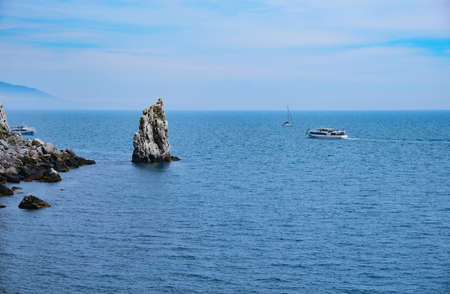 Panoramic view of blue sea, sky and mountainsの写真素材
