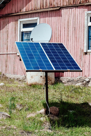 Small solar panel near old houseの写真素材