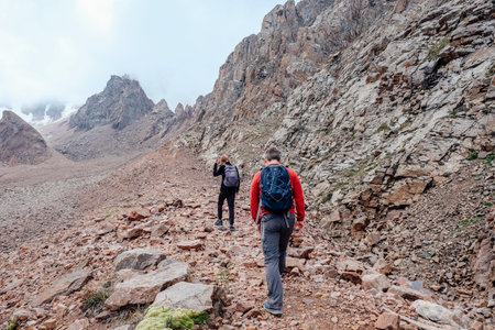 Travelers father and son in mountains