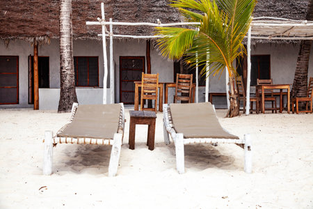 Two sunbeds on tropical sandy beach on Zanzibar, Tanzaniaの写真素材
