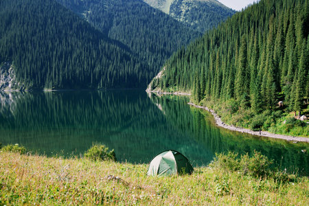 Tourist tent on the shore of a mountain lake.の写真素材