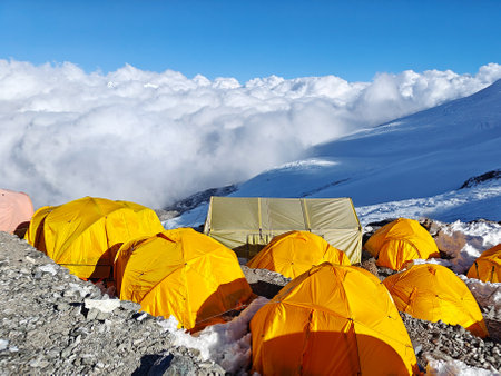 Himalayan mountain camp in Nepal, colorful tents, glacier, and clouds.の写真素材