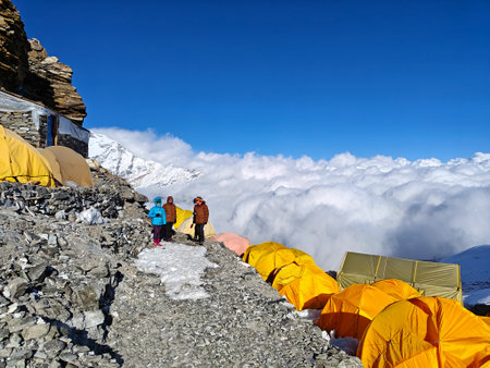 Himalayan mountain camp in Nepal, colorful tents, glacier, and clouds.