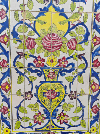 Decorative ceramic tile mural showcases intricate floral patterns and birds, creating a vibrant and...