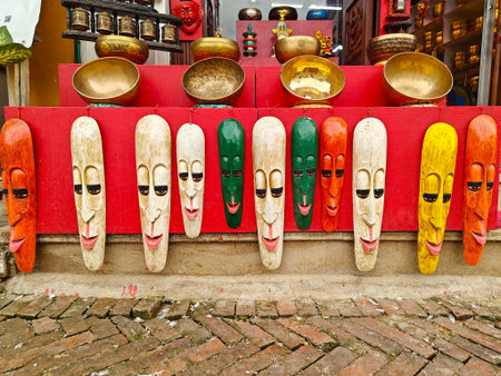 Colorful wooden masks displayed on a vibrant red wall, showcasing intricate designs and expressions in a cultural market settingの写真素材