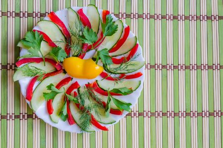 Sliced salad lined on a white plateの写真素材