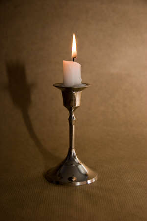 one candle on the brown backgroundの写真素材