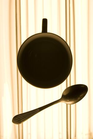 silhouette of Coffee cup and the spoonの写真素材