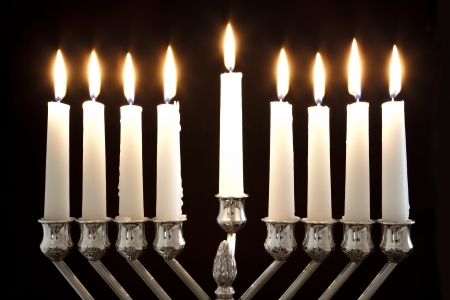 Silver Hanukkah candles all candle lite on the traditional Hanukkah menorahの写真素材