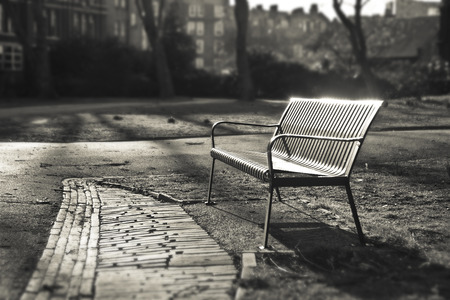 Bench in autumn park  - London, EnglandSepia colorShallow Focusの写真素材