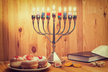 Jewish Holiday Hanukkah With Menorah, Torah, Donuts And Wooden Dreidelsの写真素材