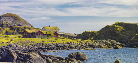 Typical Norwegian Village With Red Classic Norwegian fishing hutson (rorbu) on Lofoten islands, Norwegian traditional type of house used by fishermenの写真素材