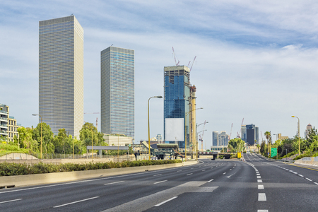 Tel Aviv Cityscape In Daylight, New Skyscraper Constraction Site and Empty Aylon Freeway. の写真素材
