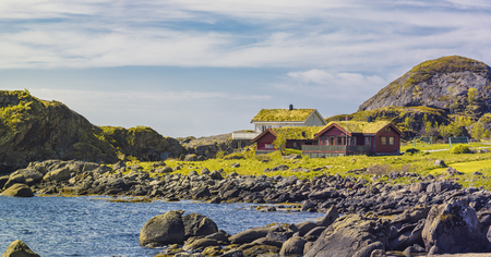Typical Norwegian Village With Red Classic Norwegian fishing hutson (rorbu) on Lofoten islands, Norwegian traditional type of house used by fishermenの写真素材