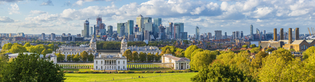 London, England, Panoramic Skyline View Of Greenwich College and Canary Wharf At Golden Hour Sunset With Blue Sky And Cloudsのeditorial素材