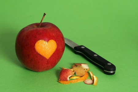 Maded heart from orange and implanted to appleの写真素材