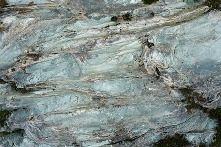 Rough blue stone texture in the forest closeup