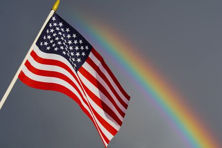 An American flag and a rainbow.