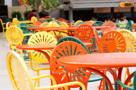 Colorful chairs and tables in a outdoor cafe. Selective focus.