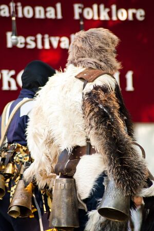 DORKOVO, BULGARIA JULY 31.2011: Internacional Folklore Festival for authentic dance. Young man dressed as "kuker" in bulgarian traditional ritual for chase the evil spirits.のeditorial素材