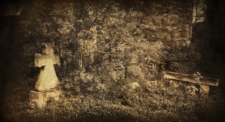 spooky vintage graveyard picture with cross in foreground