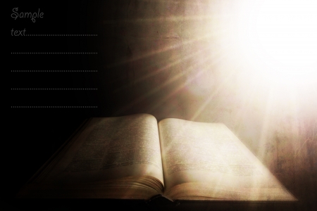 holy light over the old book; vintage textured background with space for sample textの写真素材