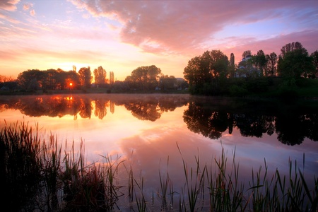 HDR lake sunrise in city parkの写真素材