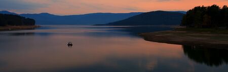 panoramic lake and boat sunset viewの写真素材