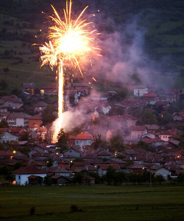 fireworks over the small village at night time の写真素材