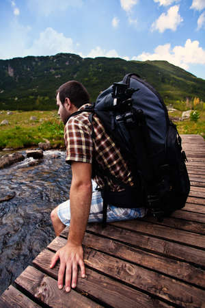 man rest on high mountain bridgeの写真素材