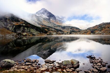 high mountain lake in bugaria; sunrise over the misty lake の写真素材