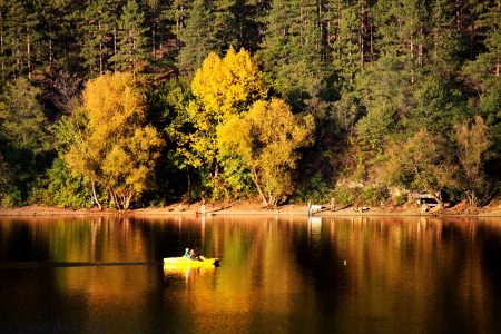 autumn leke with boat in bulgaria の写真素材