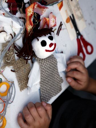 hand made doll close-up with children handの写真素材