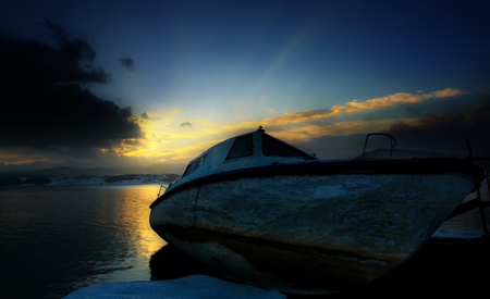dramatic HDR sunset- boat in the beachの写真素材