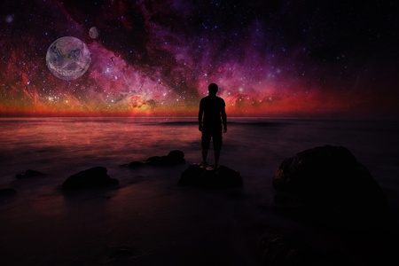 unreal landscape with man looking space- elements of this image furnished by NASA
