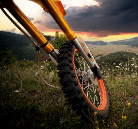 details of dirt bike in high mountain peak- sunset HDR landscapeの写真素材